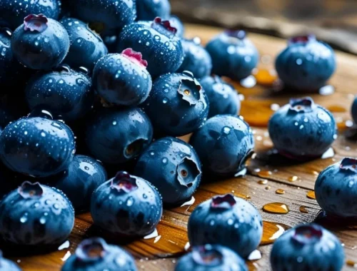 Fresh wet blueberries scattered on a wooden table